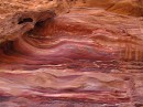 River of Rock * Just one of the thousands of pieces of colorful rock found in the mountains of Petra. Red, yellow, purple, black and tan are all mixed to create an amazing rock that looks as fluid as a river. This rock face is now slowly being eroded by the elements. * 576 x 431 * (104KB)